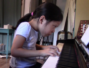 Young student playing piano