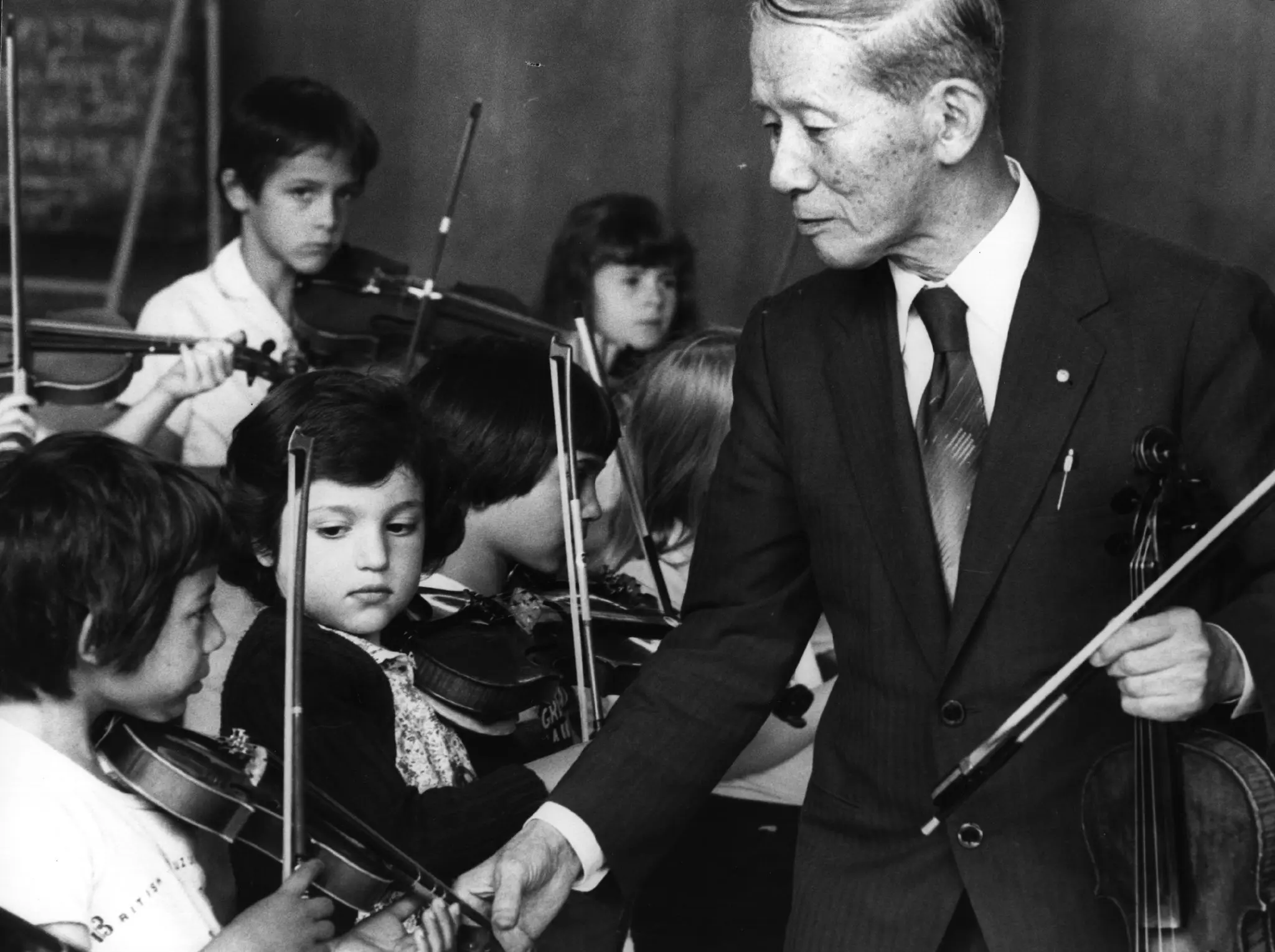 Shinichi Suzuki with young violin students