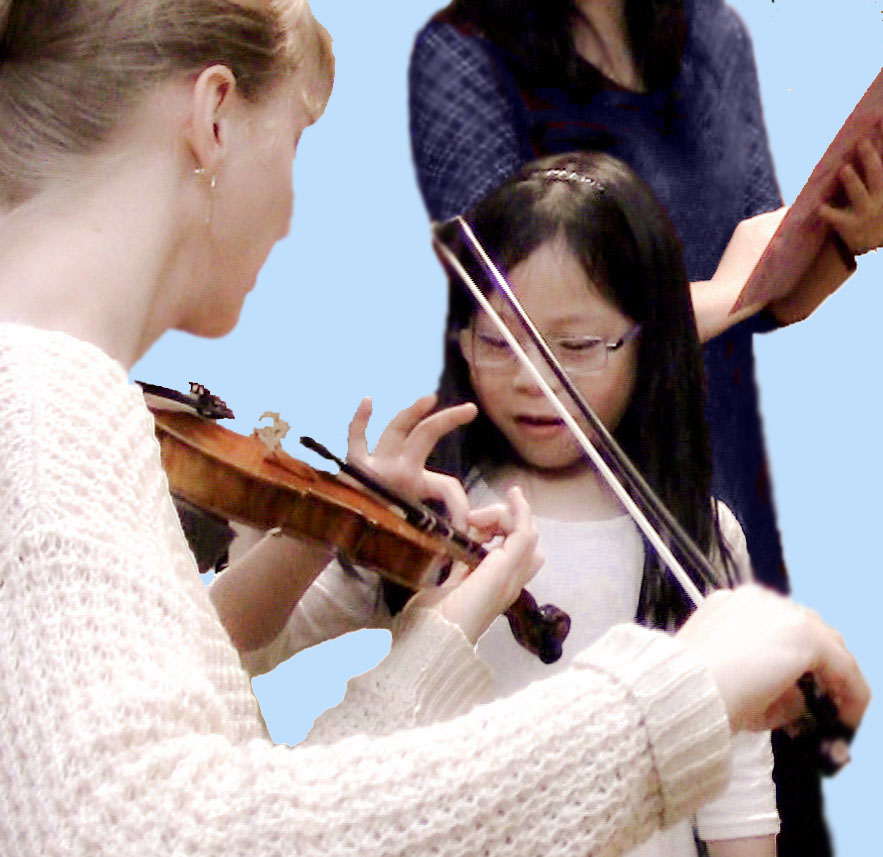 young child playing violin with teacher